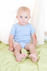 Cute child sitting in bed