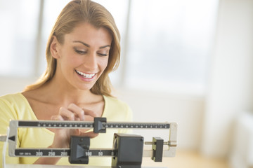 Woman Weighing Herself On Balance Scale