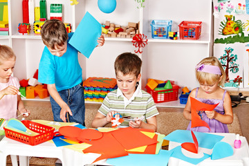 Child cutting out scissors paper.