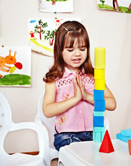 Child with  construction set in play room.