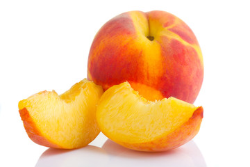 Naklejka na ściany i meble Ripe peach fruit with slices isolated on white