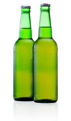 Two green bottles of beer with condensation isolated on white ba