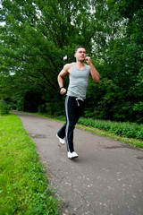 Man in black pants runs on the road