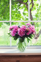 pink peonies on window sill