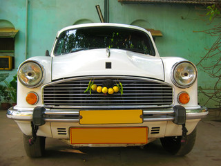 Indian white car Ambassador - VIP taxi service - Powered by Adobe
