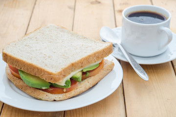 Breakfast; avocado sandwich with black coffee