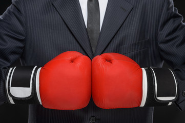 Ready to business battle. Close-up of businessman in red boxing