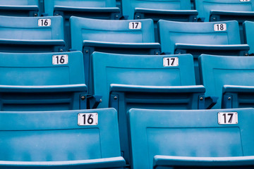 row of blue chairs in a stadium