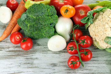 Fresh vegetables in basket on wooden table close-up