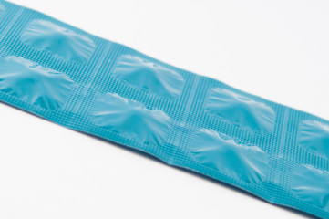 Blue aluminum foil blister strip on white background