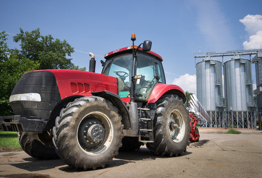 tractor in front of silos