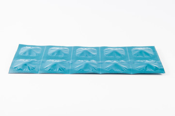 Closed up tablet in blue aluminum foil strip show medicine backg