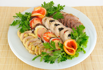 Dish with different meatloaf, sliced​​ ,decorated.