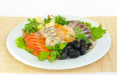 Dish with sliced ​​salmon, herring, sturgeon.