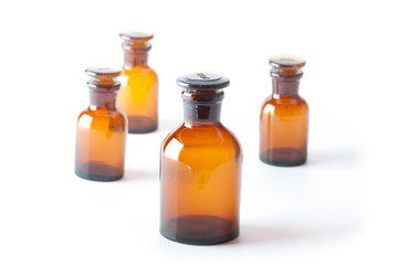 Small chemical glass bottles on white background