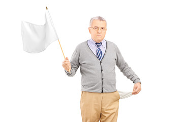 Sad senior man waving a white flag and showing his empty pocket