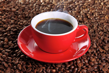 Cup of coffee on coffee beans background