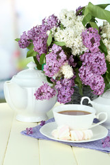 Composition with beautiful lilac flowers, tea service