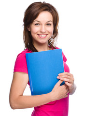 Fototapeta premium Young skinny student girl is holding exercise book