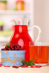 Pitcher and glass of cranberry juice with red cranberries