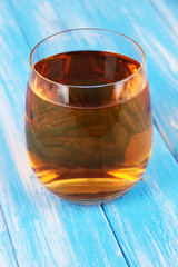 Glass of fresh apple juice on table close-up