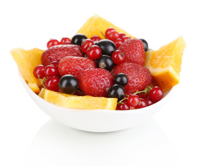 Useful fruit salad of fresh fruits and berries in bowl isolated