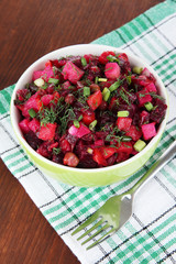 Beet salad in bowl on table close-up