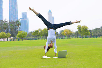 Fototapeta na wymiar woman with laptop in park