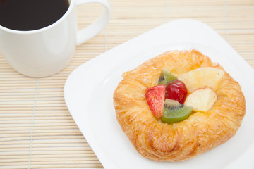 Coffee cup and croissant