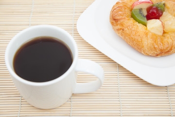Coffee cup and croissant