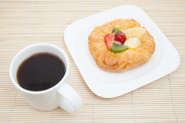 Coffee cup and croissant