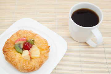 Coffee cup and croissant