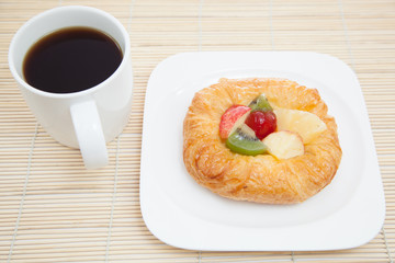 Coffee cup and croissant