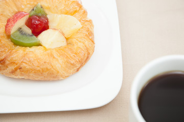 Coffee cup and croissant