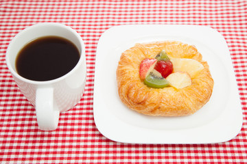 Coffee cup and croissant
