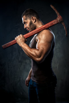 Muscular Man Holding Pickaxe