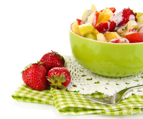 Useful fruit salad of fresh fruits and berries in bowl isolated