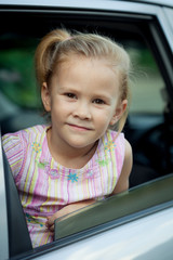 little girl sitting in the car