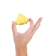 piece of pineapple in hand on a white background
