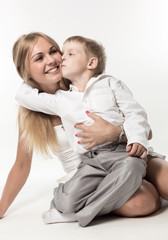 The boy embraces and kisses the woman