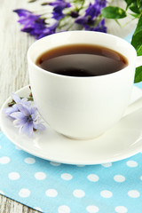 Cup of tea with chicory, on wooden table