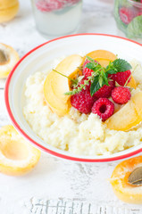 Milk porridge with raspberries and apricots