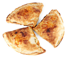 Pizza calzones on wooden board isolated on white