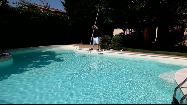 Man Cleaning Swimming Pool