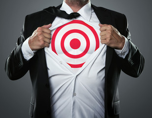 Young businessman tearing his shirt off to show target symbol