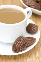 chocolate cookies madeleine and cup of coffee with milk