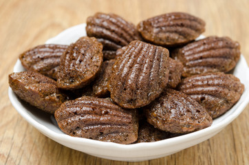 chocolate madeleines cookies on a plate, close-up