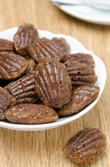chocolate madeleines cookies on a plate, vertical