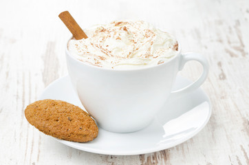 cup of cocoa with cinnamon, whipped cream and oatmeal cookies
