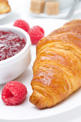 breakfast - fresh croissant, jam and raspberry